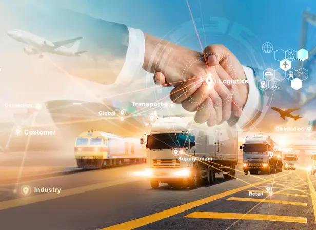 Semi truck trailer at sunset with wind turbines and solar panels in background